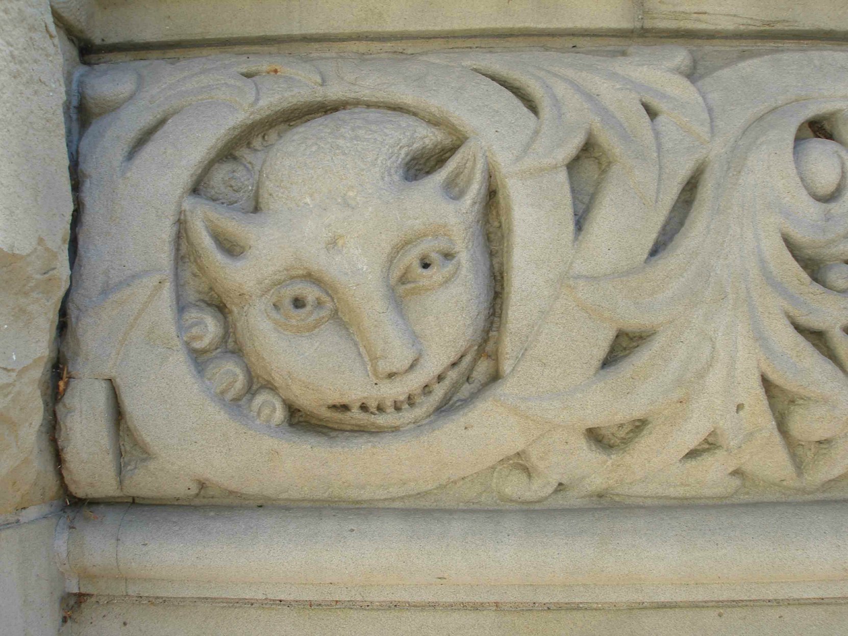 Exterior decorative detail, possibly representing the Cheshire Cat, on the stair railing of the Yates Street entrance of the former Carnegie Library, 794 Yates Street.