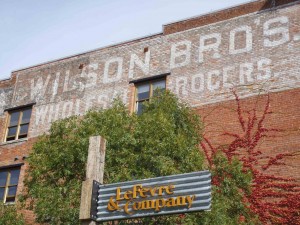 Early 20th century sign for Wilson Brothers Wholesale Grocers on the side of the Wilson Building, 532-538 Herald Street